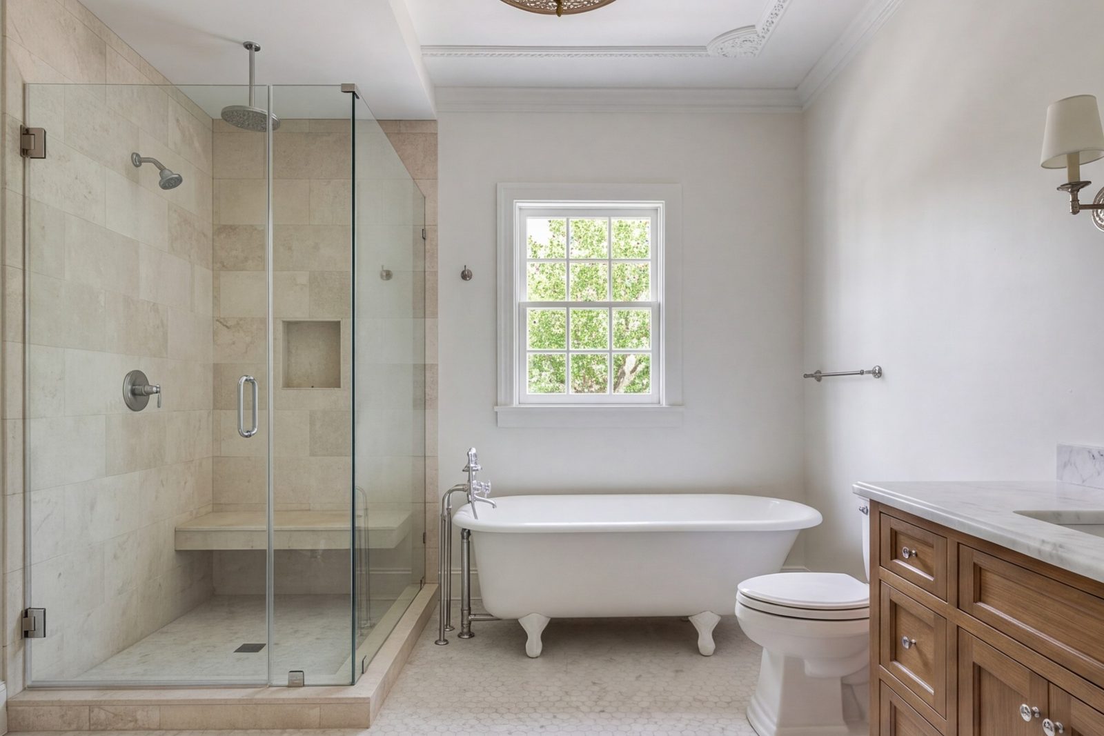 Wide view of a 1930s house primary bath with a curbless shower, pale stone and a small window